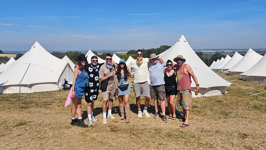 Boomtown 2026, group photo in Skylark. group of 7 in front of white bell tents 