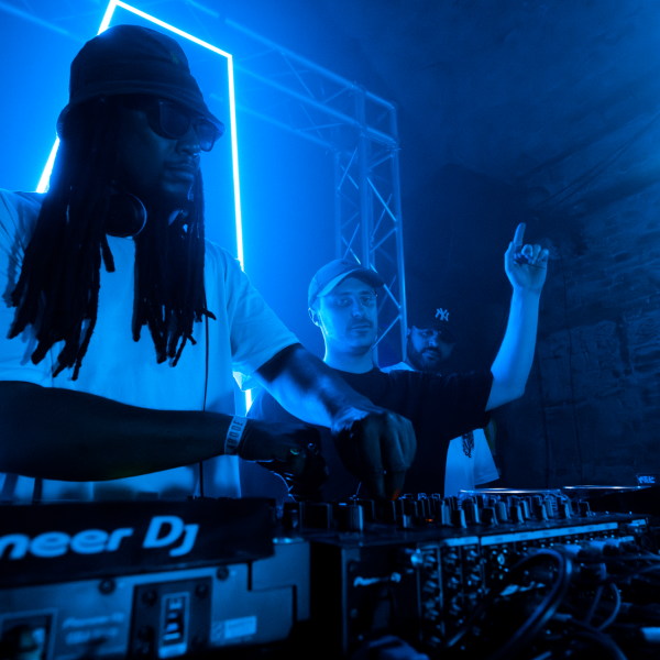 Mas Fuego DJ Collective and Producers playing music at event